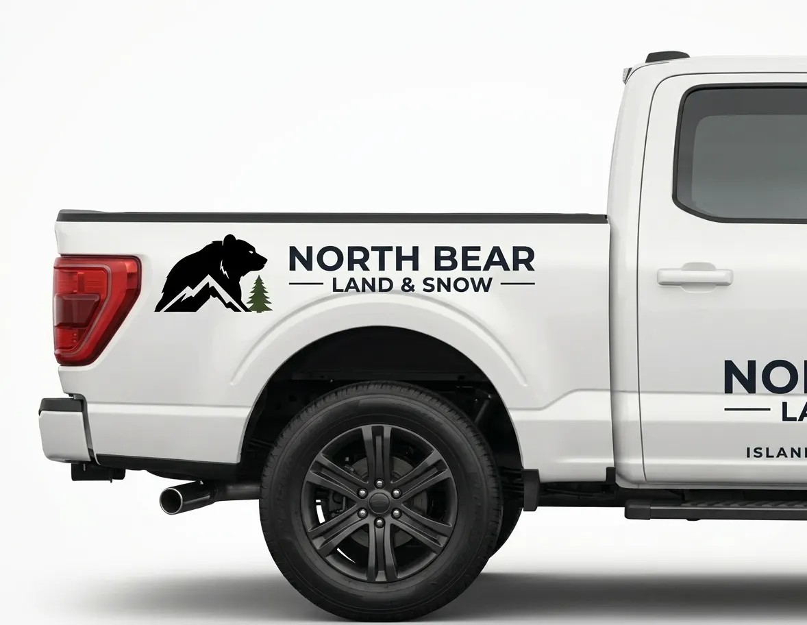 Side view of a branded North Bear Land and Snow pickup truck